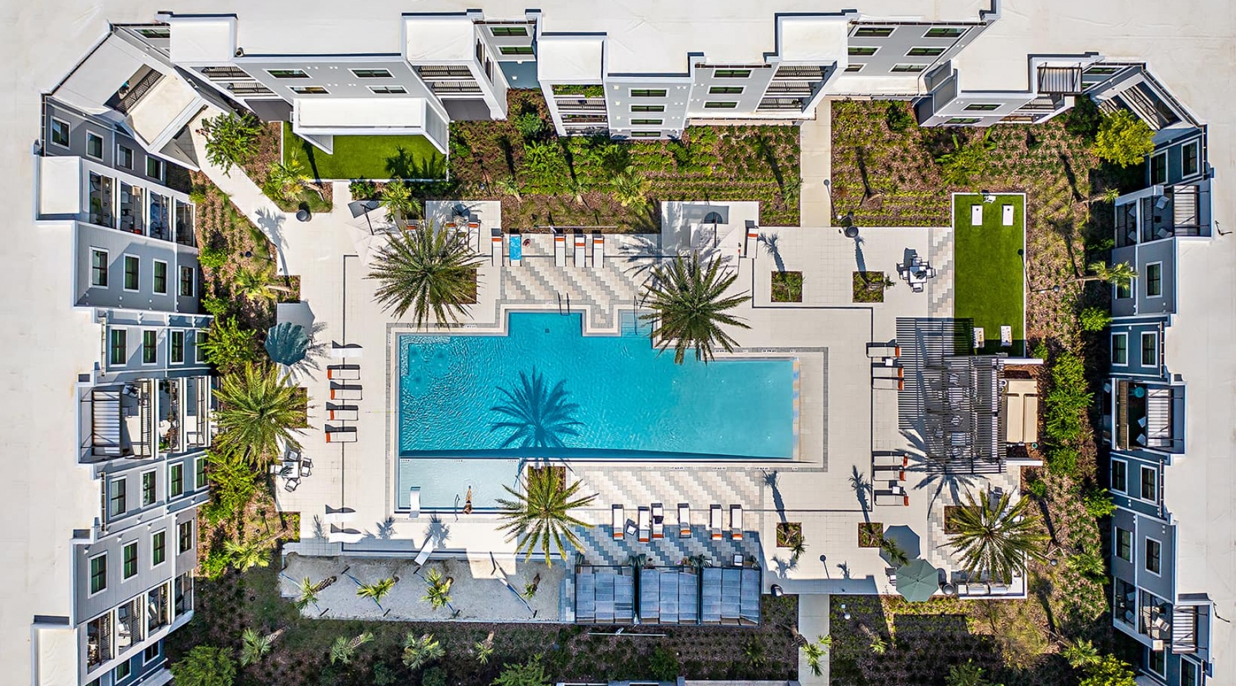 Luxurious Resort Inspired Living aerial view of inner courtyard that includes a pool and tropical landscaping