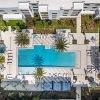 aerial view of inner courtyard that includes a pool and tropical landscaping
