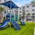playground area with lush turf and tropical landscaping