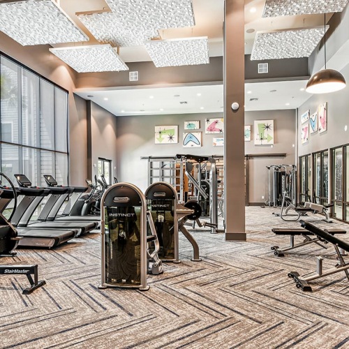 Fitness Center fitness center with ample equipment and modern ceiling decor
