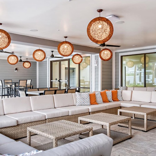 Lounge Area spacious wall-to-wall style couch seating with modern hang-lights and nearness to outside courtyard