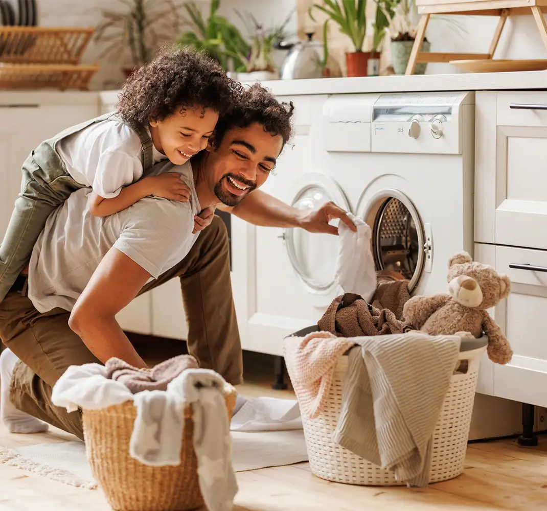 dad and son doing laundry