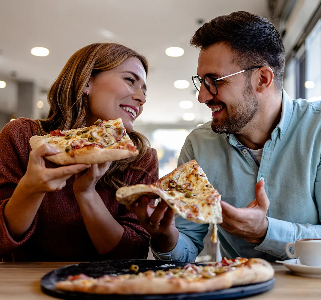 couple enjoying pizza